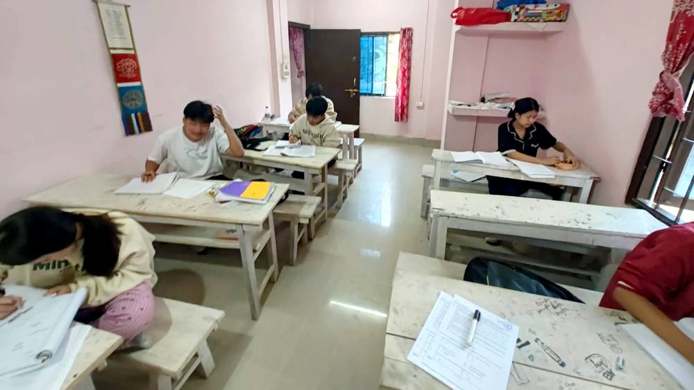 Students studying quietly at benches inside the Omega Tutorial classroom